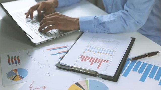 business analysis - man working with financial data charts and graphs at office