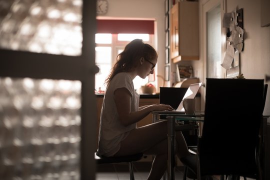 Woman using laptop at home