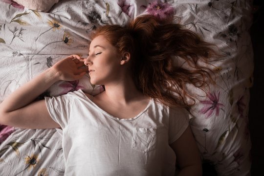 Woman sleeping in bedroom