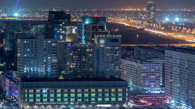 Aerial skyline of Abu Dhabi city centre from above night timelapse