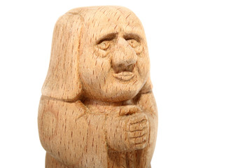 Fototapeta na wymiar Figurine of a Monk carved from beech. Portrait of fairytale character