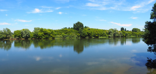 peaceful banks with trees of the Dordogne River in New Aquitaine in the south-west of France, near Bergerac