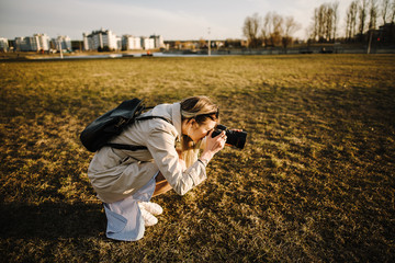 Portrait of a beautiful young blond woman with a camera, lifestyle