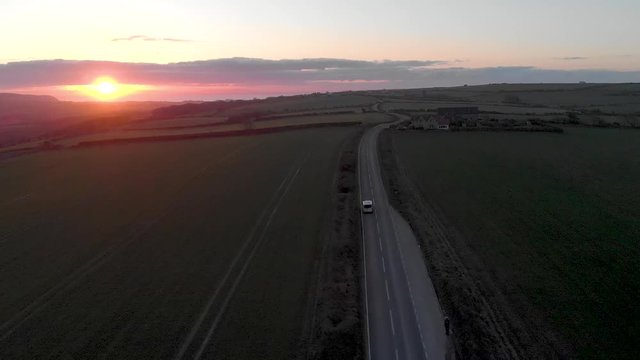Sunrise shot of a van driving along a country road in dorset uk.