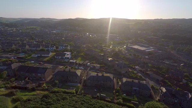 Aerial reveal of a Scottish town at sunset or sunrise