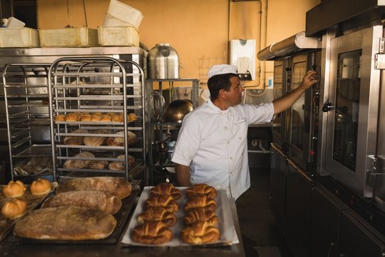 Male baker working in baker shop