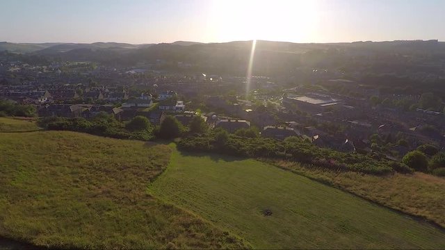 Aerial reveal of a Scottish town at sunset or sunrise