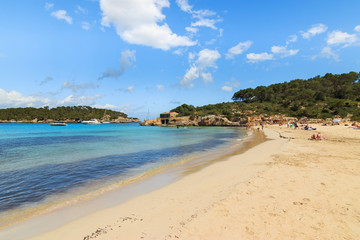 Sandy beach and clear blue turquoise waters in a island of Mediterranean Sea. Holidays concept in Cala Mondrago natural park. Majorca in Balearic Islands Spain.