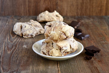 Chocolate meringue on wooden background, homemade