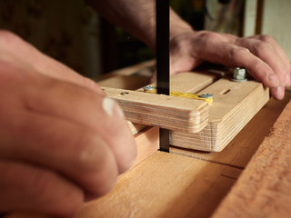 Lautner makes a classic guitar. Making slots in the lining.