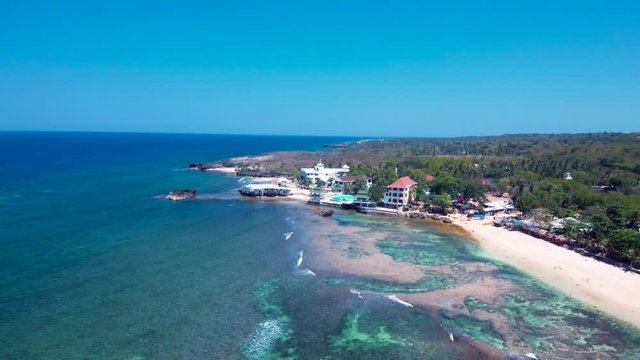 A white sand beach with blue waters in an exotic place in the Philippines, southeast asia.