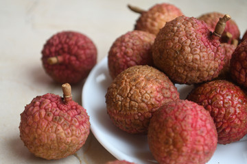 Fresh and juicy lychees on neutral background.