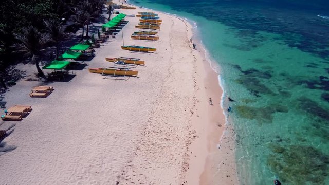Aerial drone shots of a white sand beach with blue waters in an exotic place in the Philippines, southeast asia