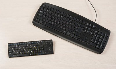 bluetooth keyboard and wired keyboard, on the table, top view