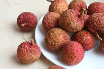 Fresh and juicy lychees on neutral background.