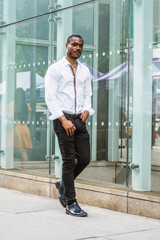 Young African American Man with beard, traveling in New York, wearing white shirt, black pants,...