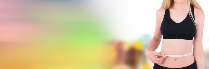 Woman measuring weight with measuring tape on waist on Summer