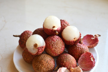 Fresh and juicy lychees on neutral background.