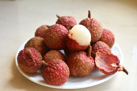 Fresh and juicy lychees on neutral background.
