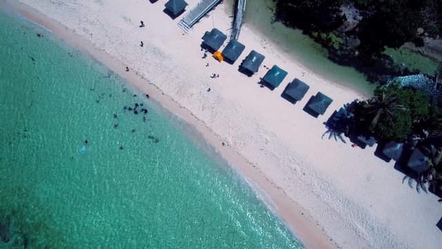 Aerial drone shots of a white sand beach with blue waters in an exotic place in the Philippines, southeast asia