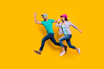 Portrait of athletic sportive students running fast wearing jeans casual clothes isolated on bright...