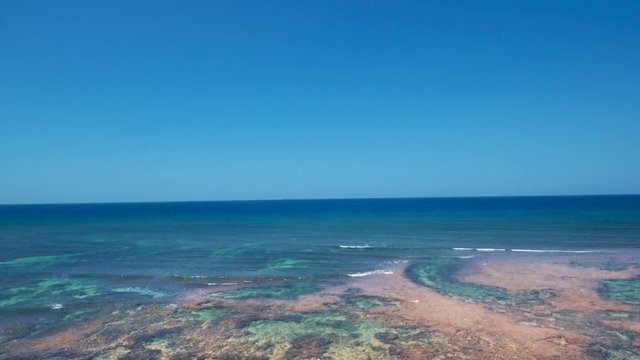 Aerial drone shots of a white sand beach with blue waters in an exotic place in the Philippines, southeast asia