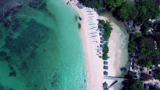 Aerial drone shots of a white sand beach with blue waters in an exotic place in the Philippines, southeast asia