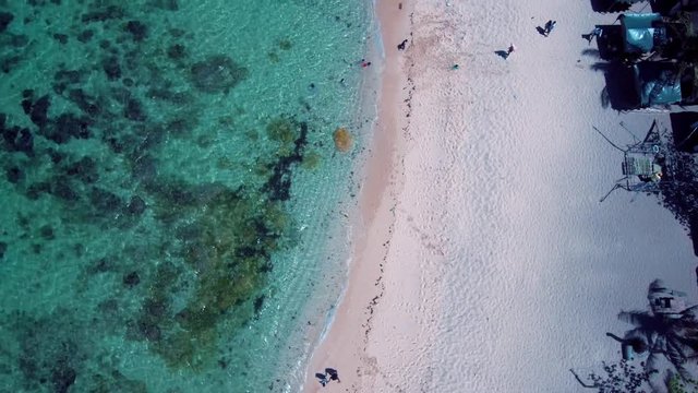 Aerial drone shots of a white sand beach with blue waters in an exotic place in the Philippines, southeast asia