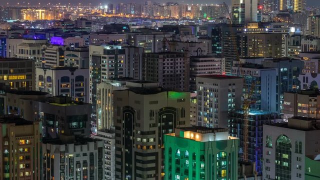 Aerial skyline of Abu Dhabi city centre from above night timelapse