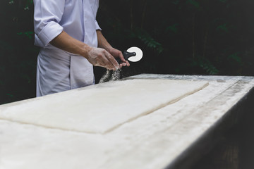 Chef cooking show in the garden on prepares the dough with flour in matte color
