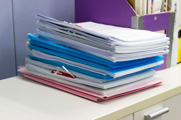 stack of papers documents on file cabinet in Office, business concept.
