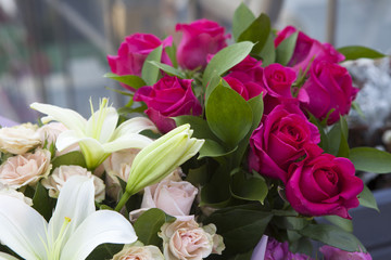 the White lilies and colorful roses in kraft paper as a birthday present
