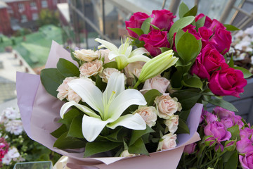 the White lilies and colorful roses in kraft paper as a birthday present