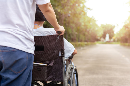 Caretaker With Patient In Wheelchair