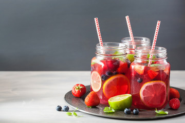 summer berry lemonade with lime and mint in mason jar
