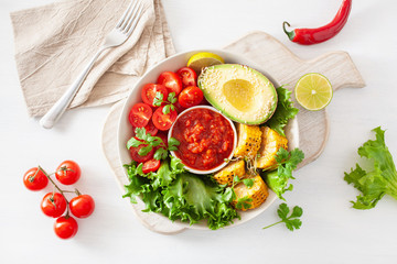 vegan buddha bowl. healthy lunch bowl with avocado, tomato, sweet corn and salsa