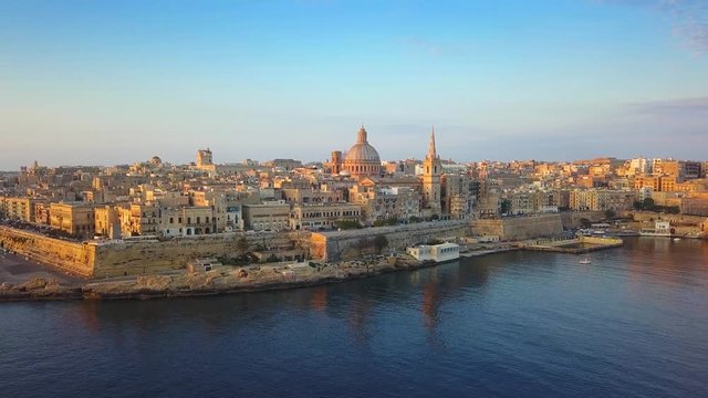 Valletta, Malta - 4K flying towards St.Paul's Cathedral and Our Lady of Mount Carmel Basilica at Valletta on a summer morning