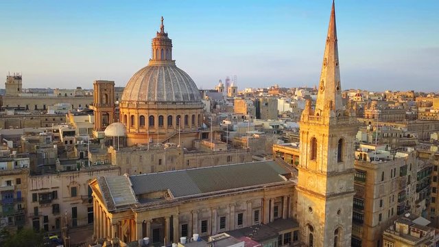Valletta, Malta - 4K flying above St.Paul's Cathedral and Our Lady of Mount Carmel Basilica at Valletta on a summer morning
