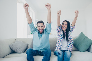 Inspiration motivation concept. Portrait of excited active couple holding raised hands celebrating...