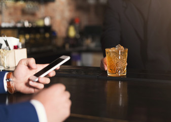 Bartender giving drink to customer in bar