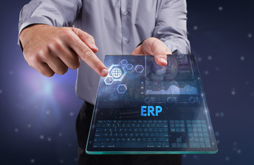 The concept of business, technology, the Internet and the network. A young entrepreneur working on a virtual screen of the future and sees the inscription: ERP