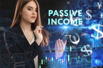 The concept of business, technology, the Internet and the network. A young entrepreneur working on a virtual screen of the future and sees the inscription: Passive income