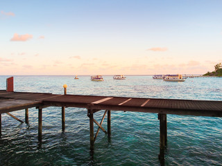 Wooden bridge over the turquoise water sea.