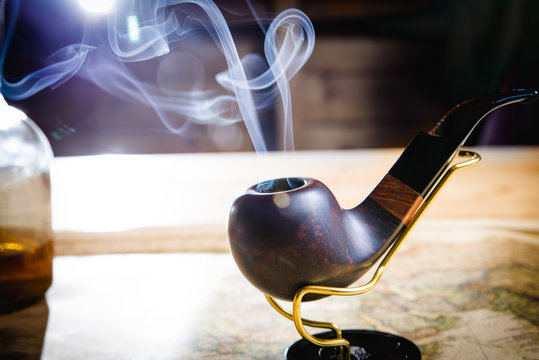 Smoking pipe on a wooden table