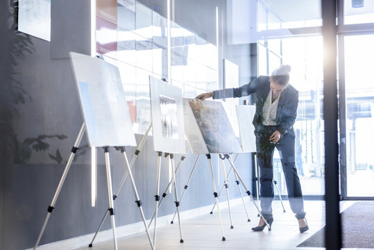 Businesswoman checking ideas boards in office