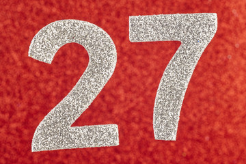 Number twenty-seven silver color over a red background. Anniversary