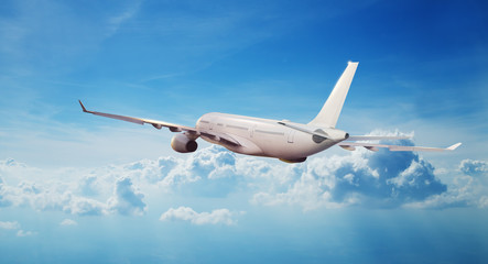 Commercial airplane jetliner flying above clouds