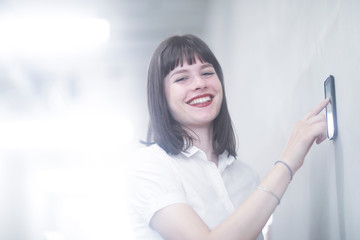 Woman using wall mounted touch screen control panel