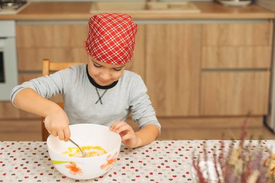 Boy mixing ingredients in a bowl while cooking
