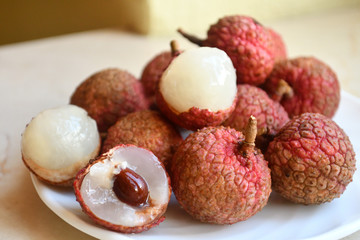 Fresh and juicy lychees on neutral background.